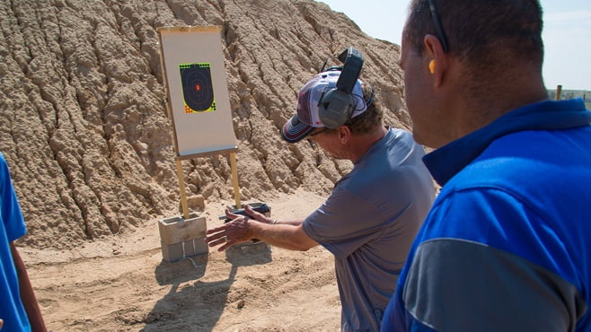 Photo of new shooter examining outdoor target